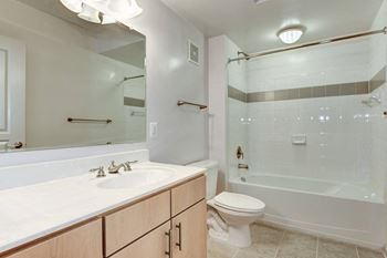 A bathroom with a sink toilet and a shower